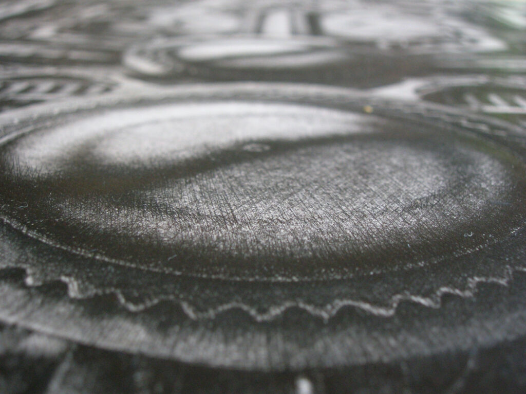 Macro photograph with unusual perspective of the ink drawing on cardboard titled "Mechanism 4"